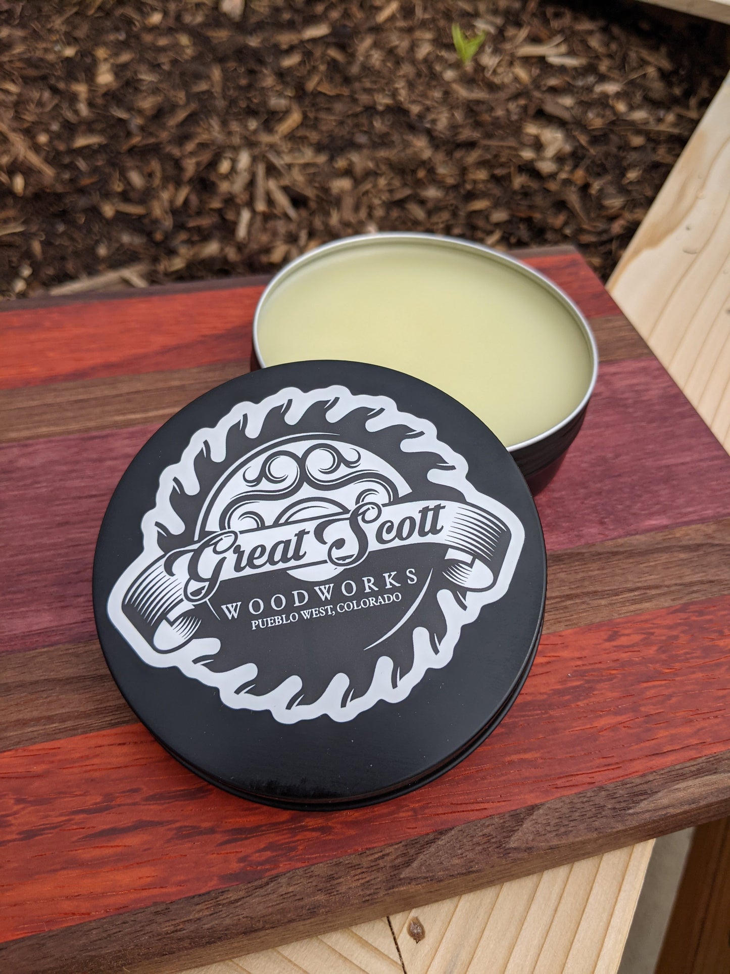 Great Scott Woodworks board wax tin with branded logo lid, included with every handmade walnut purpleheart padauk bar board