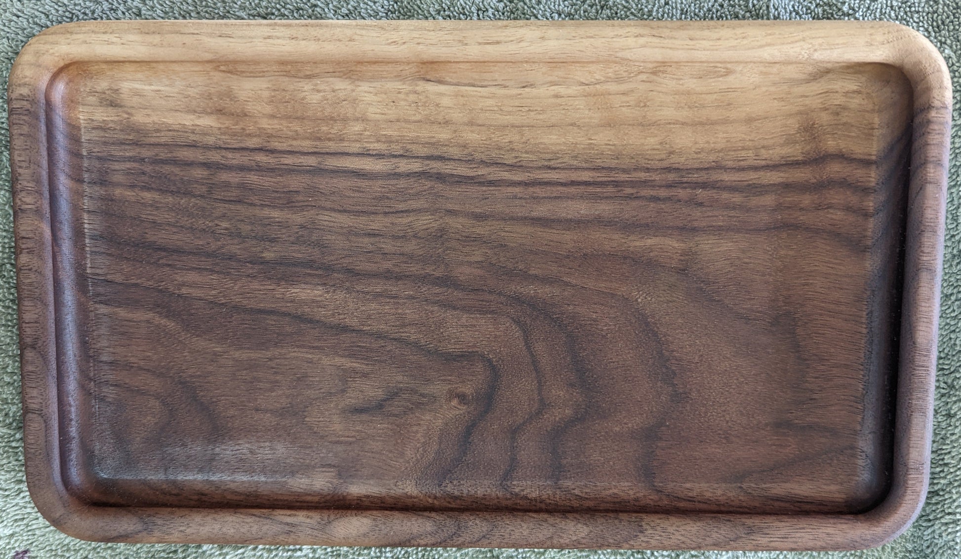 Top-down view of walnut catch-all tray showing natural color and grain variation within a single piece of wood