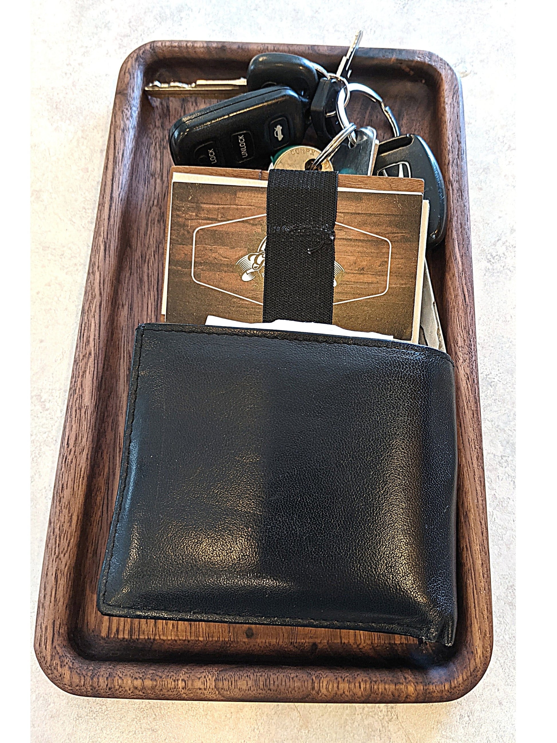 Small walnut catch-all tray filled with a wallet, keys, and business card holder
